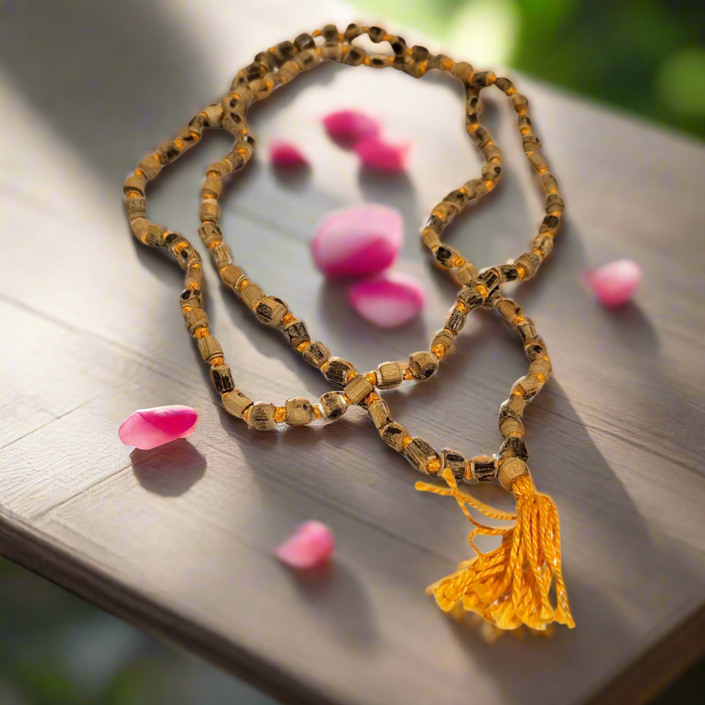 Wooden beaded necklace with a yellow tassel on a white background