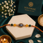 Citrine & Green Jade Rakhi with Evil Eye Charm – Crystal Rakhi for Prosperity, Protection & Positive Energy